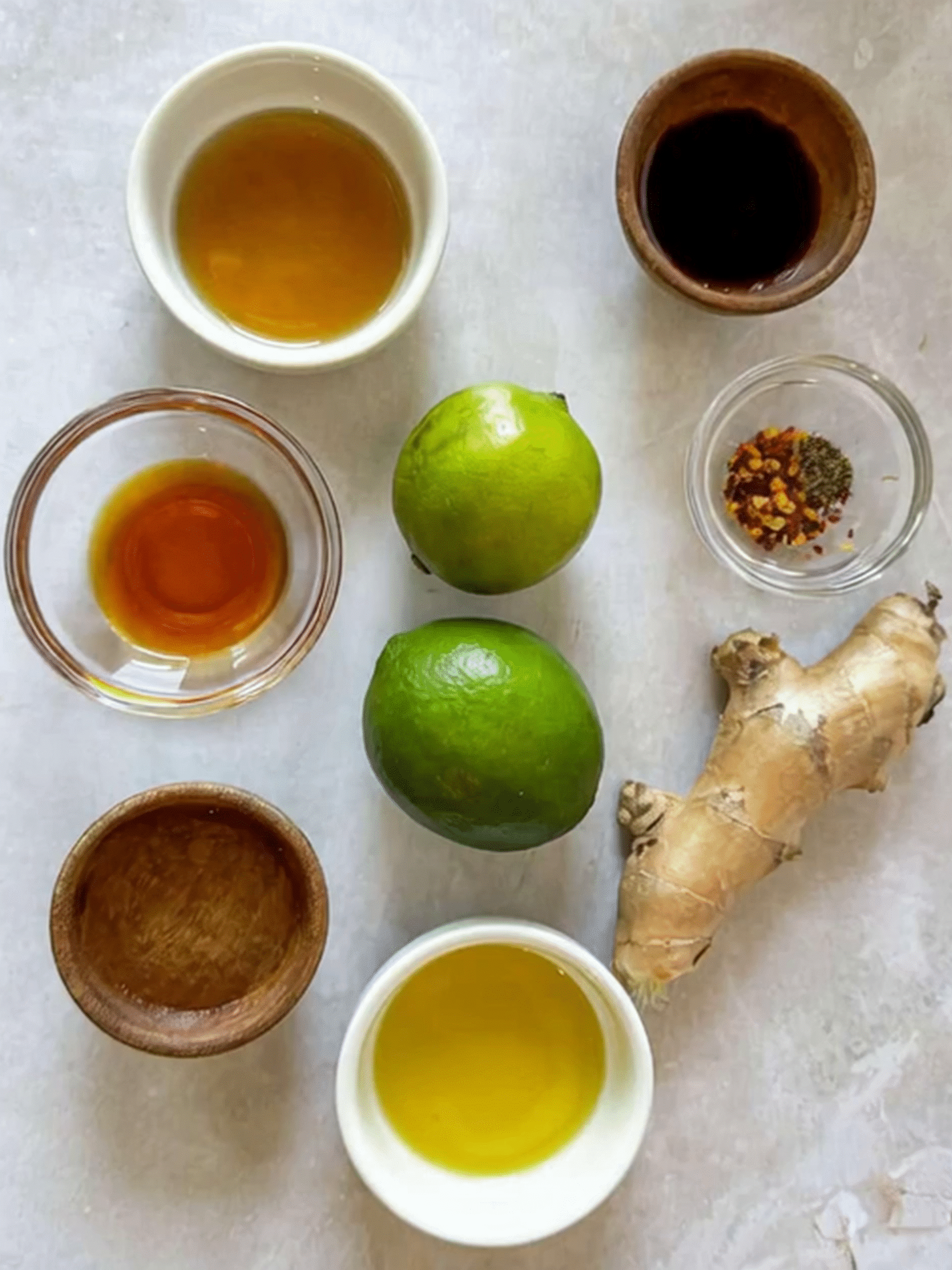 Asian Crunchy Salad Sesame Ginger Dressing Ingredients Ingredients for Asian Crunchy Salad dressing including lime, soy sauce, fish sauce, sesame oil, ginger, chili flakes, and rice vinegar