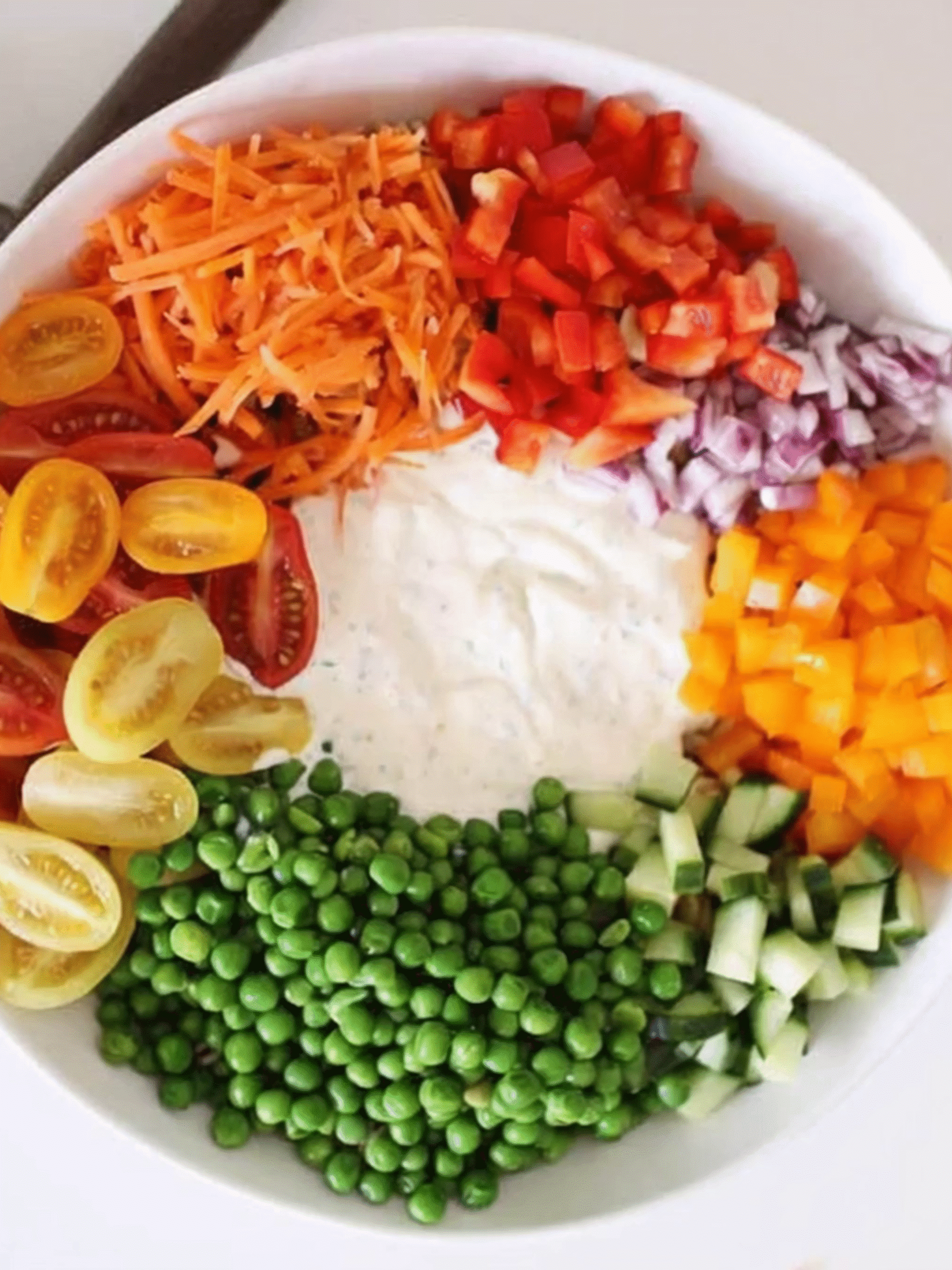 Creamy Summer Pasta Salad Ingredients Before Mixing Bowl of creamy summer pasta salad ingredients with dressing in the center, surrounded by fresh vegetables