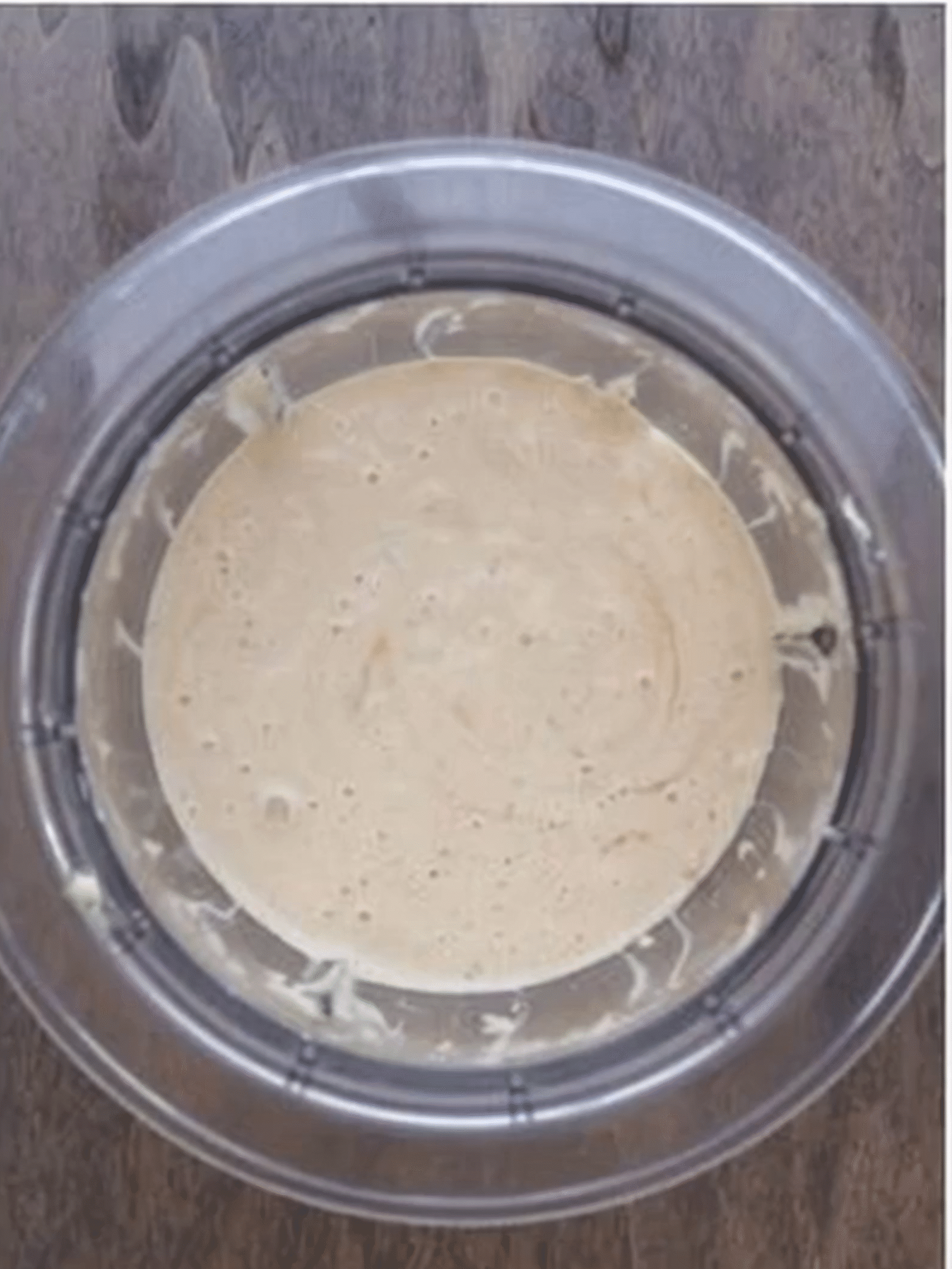 Creamy Italian Pasta Salad Dressing in a Mixing Bowl Homemade creamy Italian dressing in a glass bowl on a wooden surface