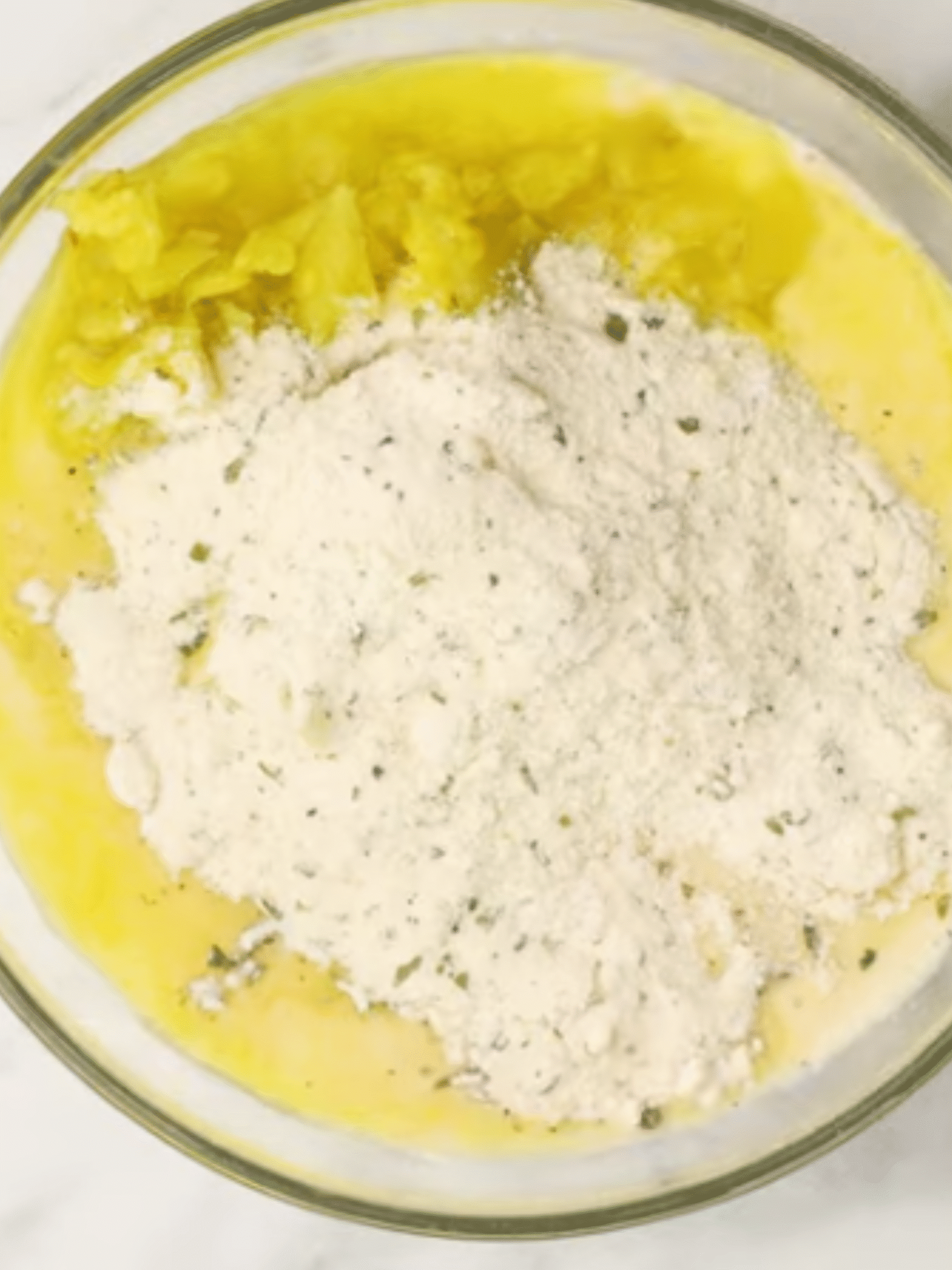 Chicken Ranch Dressing Preparation Bowl with creamy ranch dressing ingredients including mayonnaise, milk, seasoning mix, and pepperoncini