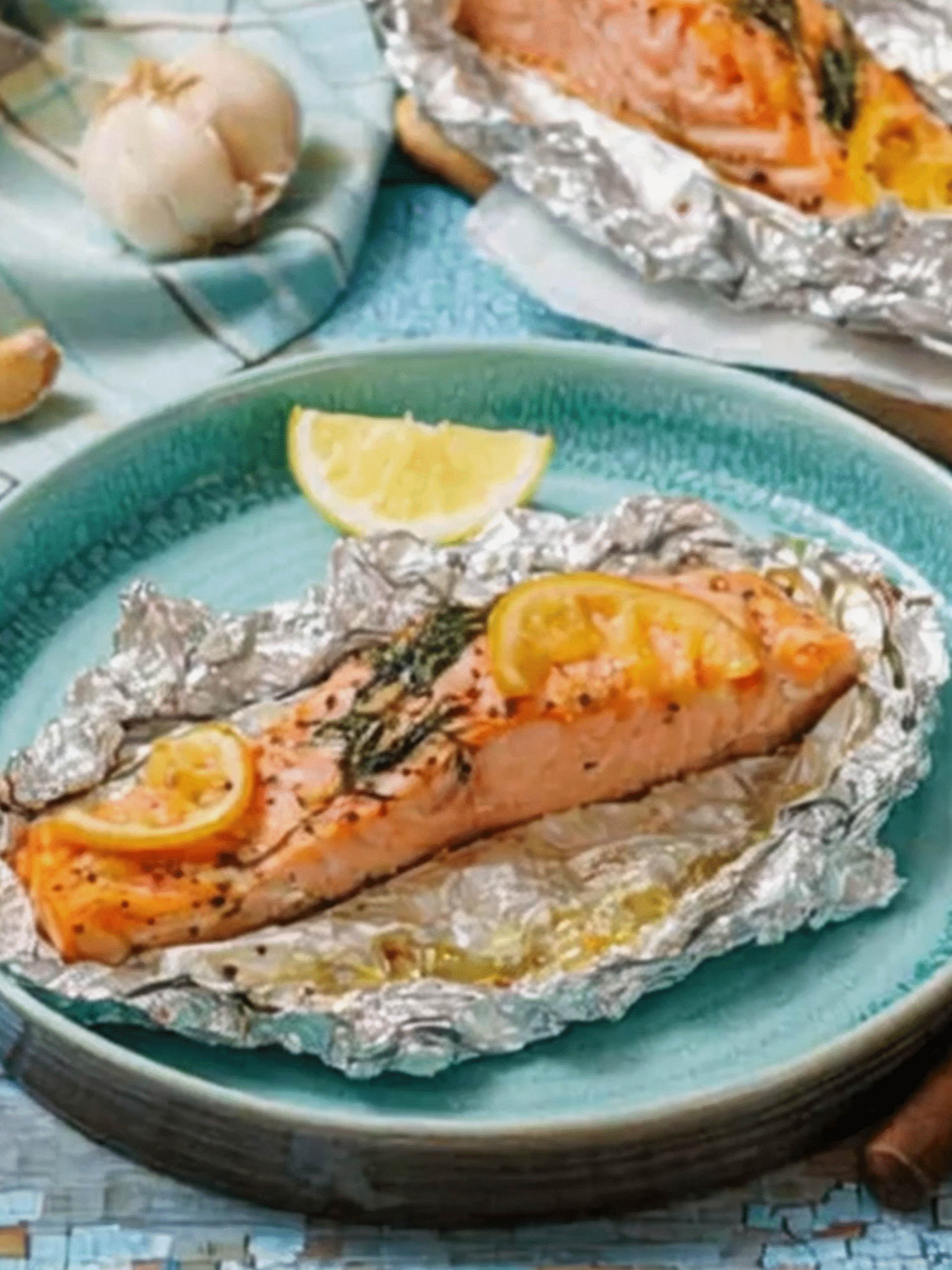 Lemon Herb Foil Grilled Salmon Ready to Serve Cooked salmon fillet in foil with lemon and herbs served on a plate