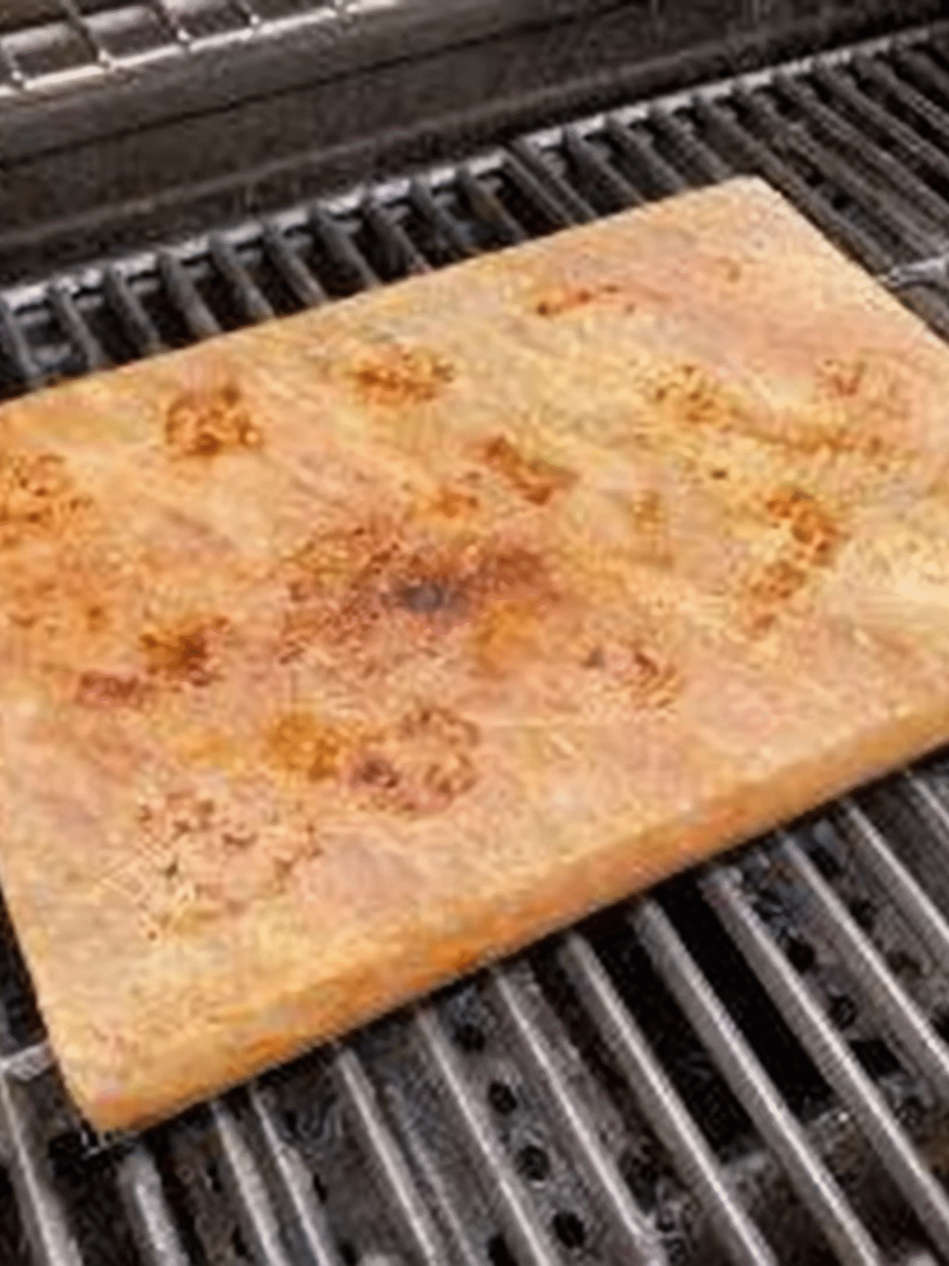 Preheating Himalayan Salt Block on Grill Himalayan pink salt block heating on a grill before cooking