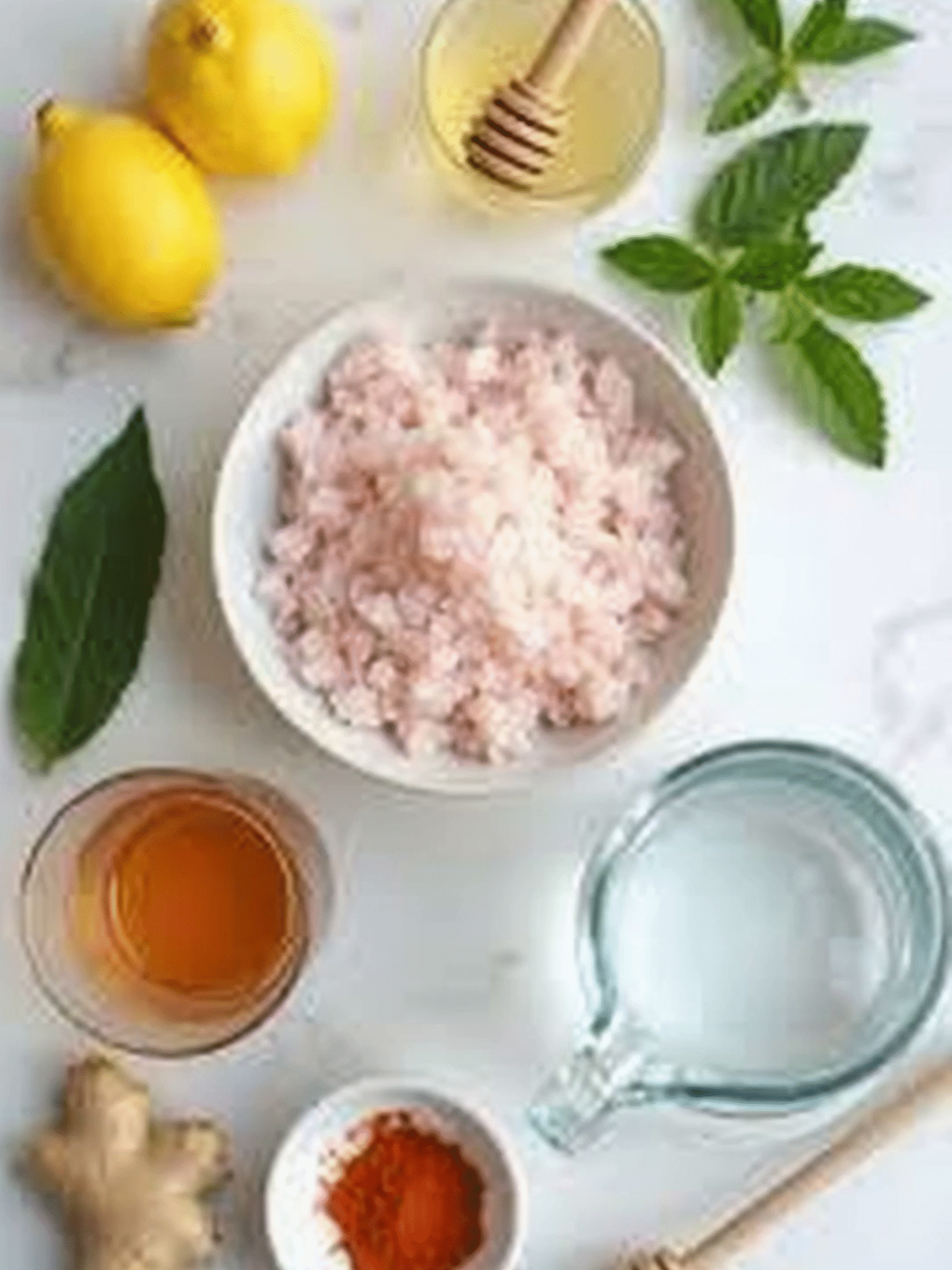 Pink Salt Weight Loss Recipe Ingredients Flat Lay Ingredients for pink salt weight loss recipe including Himalayan salt, lemon, honey, ginger, cayenne, apple cider vinegar, and water