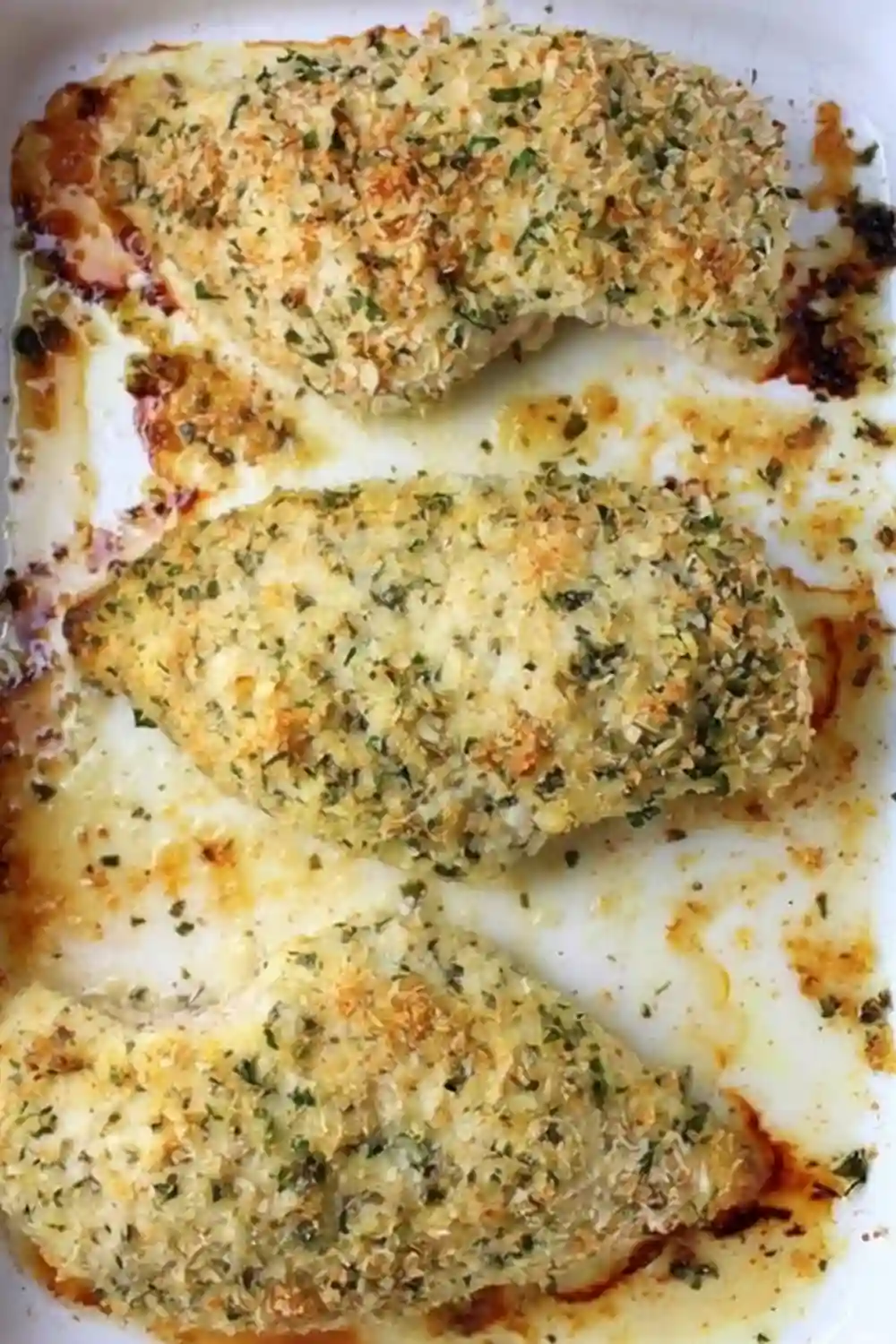 Baked Parmesan Crusted Chicken with Crispy Herb Crust Oven-baked Parmesan Crusted Chicken breasts with golden crispy breadcrumb and herb topping