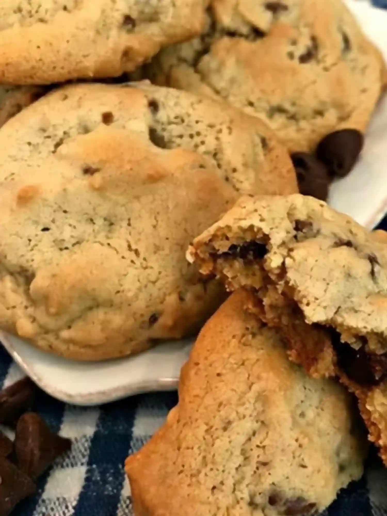 Magnolia Chocolate Chip Cookie Recipe chewy cookies on a plate with melted chocolate chips inside