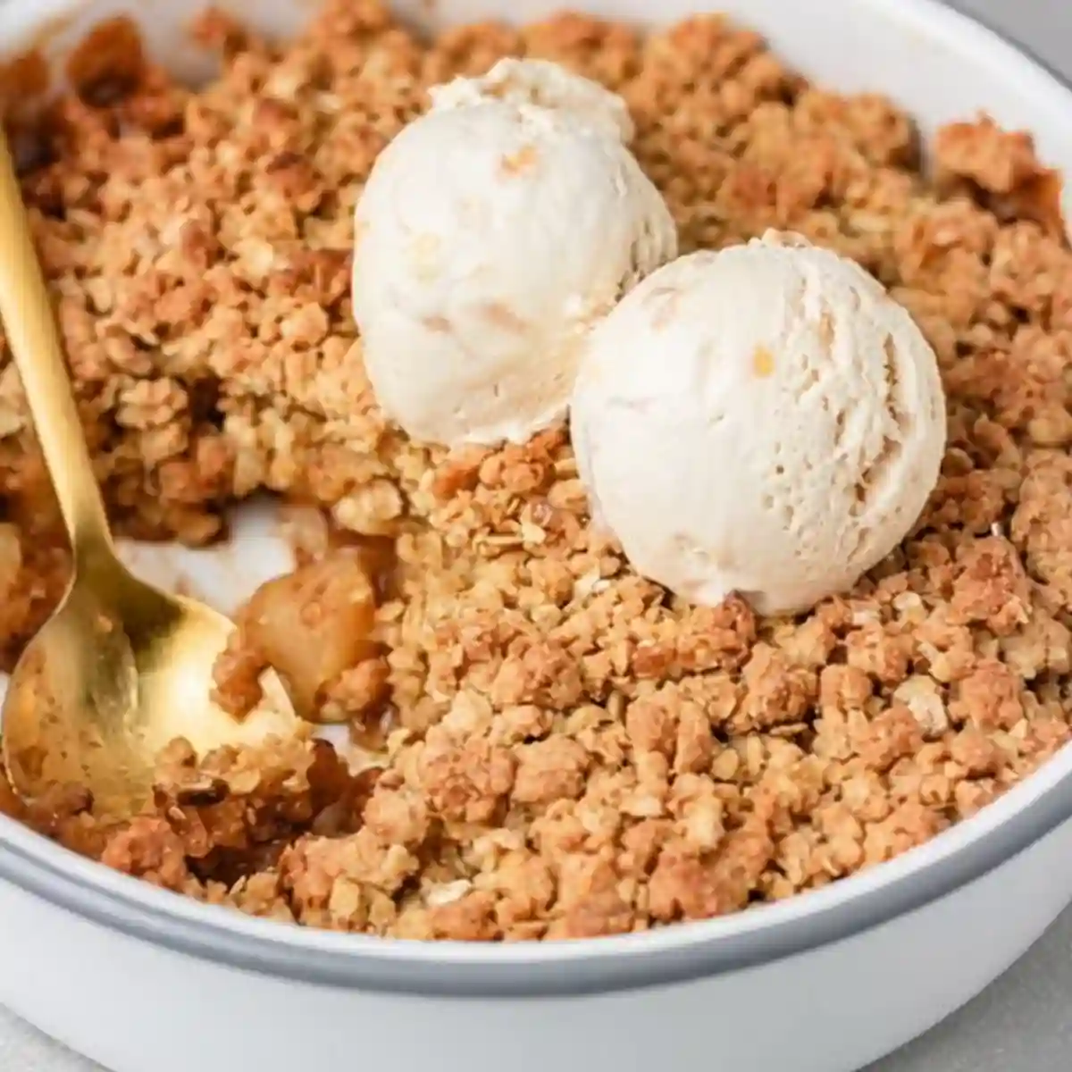Simple Apple Crumble Apple Crisp served with vanilla ice cream in a white dish