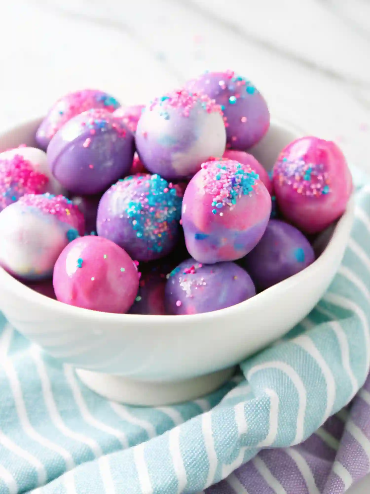 Candied grapes recipe featuring galaxy-style grapes coated in colorful candy shell with pink and blue sprinkles.