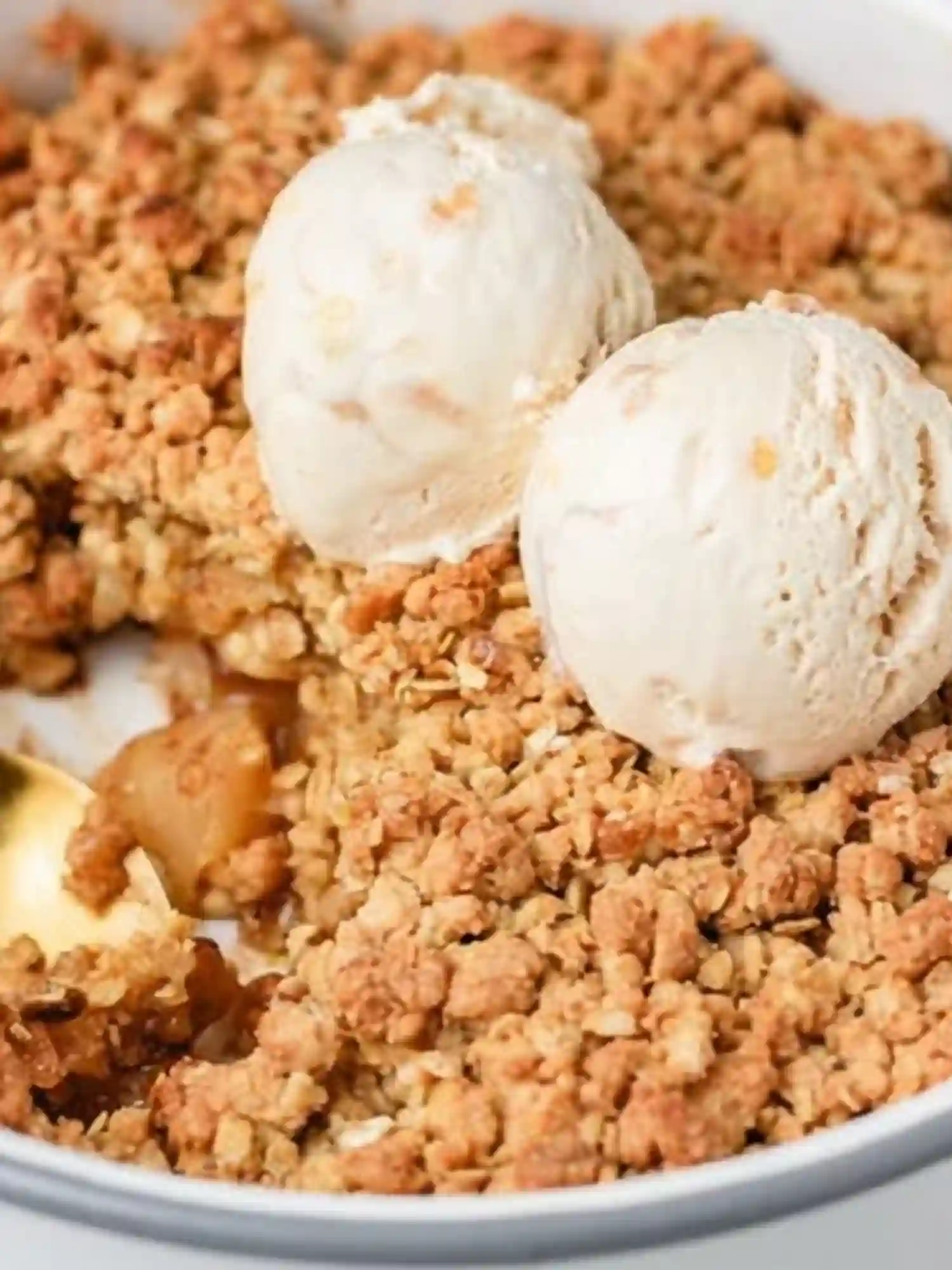 Simple Apple Crumble Apple Crisp served with vanilla ice cream in a white dish