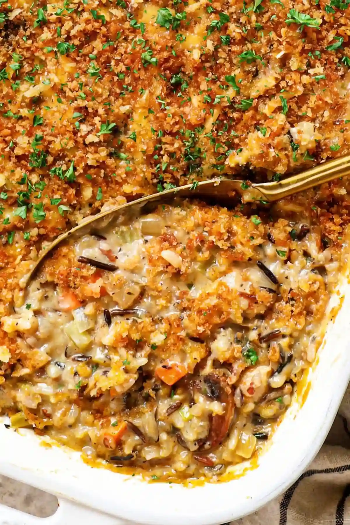 Creamy chicken rice casserole fall with golden panko topping and fresh herbs