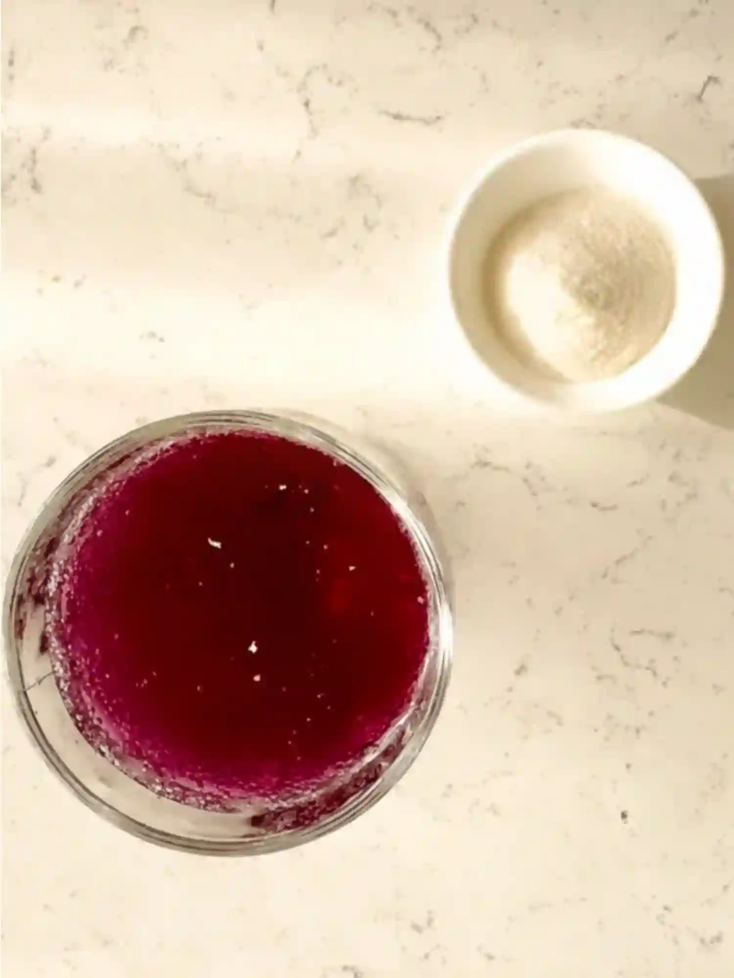 Ingredients for Dr Oz Pink Gelatin Recipe for Weight Loss Ingredients for Dr Oz Pink Gelatin Recipe for Weight Loss including unflavored gelatin powder and cranberry mixture on a white marble counter