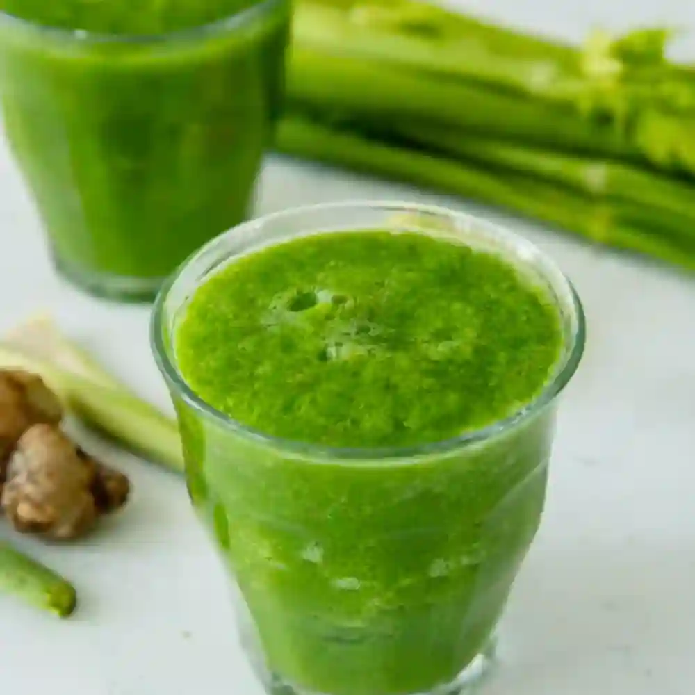 Best Detox Smoothie for Weight Loss served in a clear glass with fresh celery and ginger in the background on a clean white surface