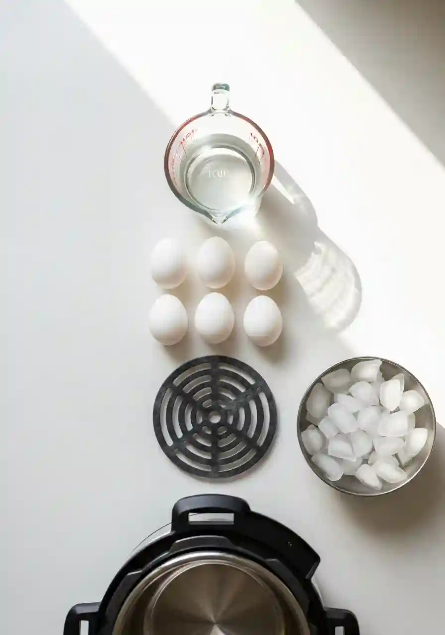 Instant Pot Hard Boiled Eggs ingredients including eggs, water, trivet, and ice bowl laid out before cooking