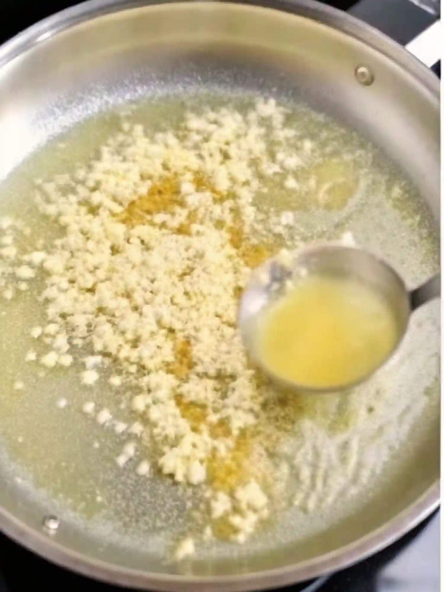 butter and milk melting together in pan for garlic parmesan pasta sauce
